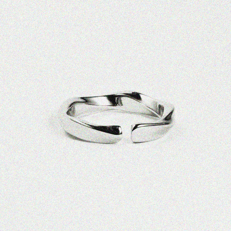 A sleek silver ring featuring a stylish curved design, perfect for adding a touch of elegance to any outfit
