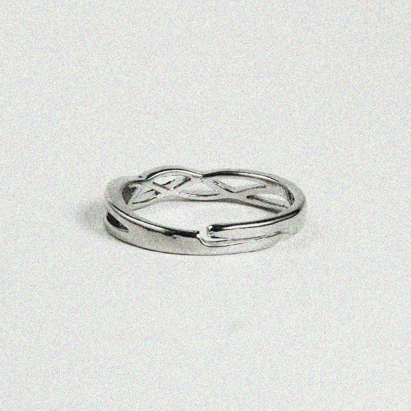 1. A close-up of a silver ring featuring a stylish twisted design, showcasing its elegant curves and shiny finish.

2. A silver ring with a unique twisted design, highlighting its intricate details and polished surface.

3. A beautifully crafted silver ring with a twisted pattern, emphasizing its modern and chic look.