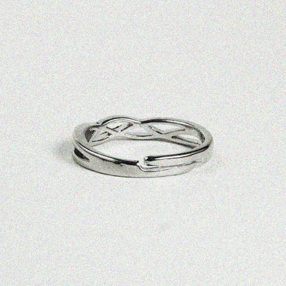 1. A close-up of a silver ring featuring a stylish twisted design, showcasing its elegant curves and shiny finish.

2. A silver ring with a unique twisted design, highlighting its intricate details and polished surface.

3. A beautifully crafted silver ring with a twisted pattern, emphasizing its modern and chic look.