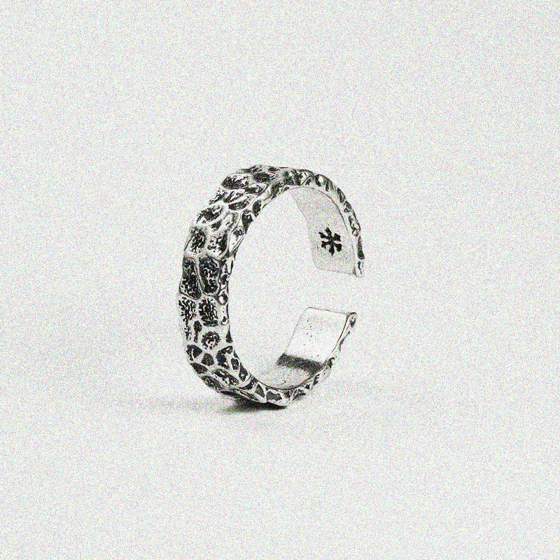 1. A silver ring featuring a delicate flower design, showcasing elegance and charm in its intricate details.

2. A beautifully crafted silver ring adorned with a floral pattern, perfect for adding a touch of nature-inspired style.

3. A stunning silver ring with a unique flower design, blending sophistication and natural beauty in one piece.

