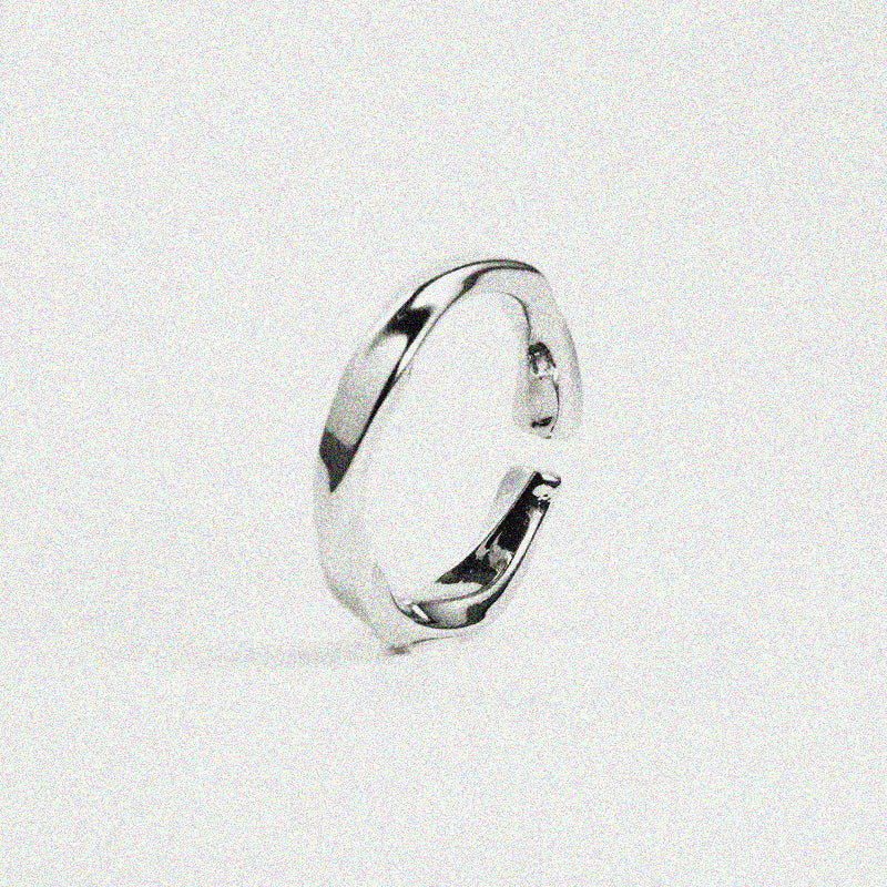 A modern silver ring showcasing a unique curved design, ideal for those who love minimalist jewelry.
