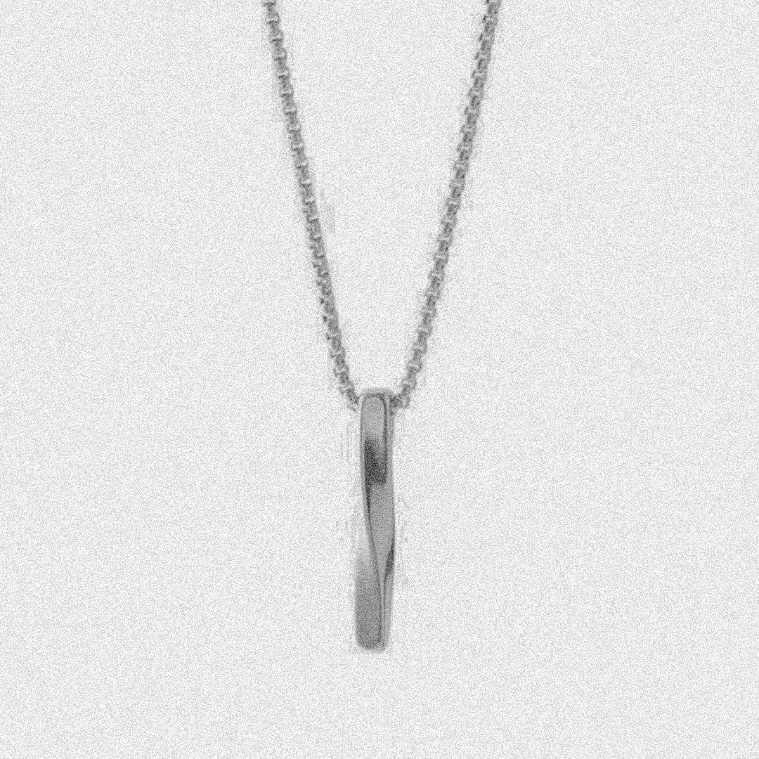 A delicate silver necklace featuring a small, elegant cross pendant hanging gracefully.